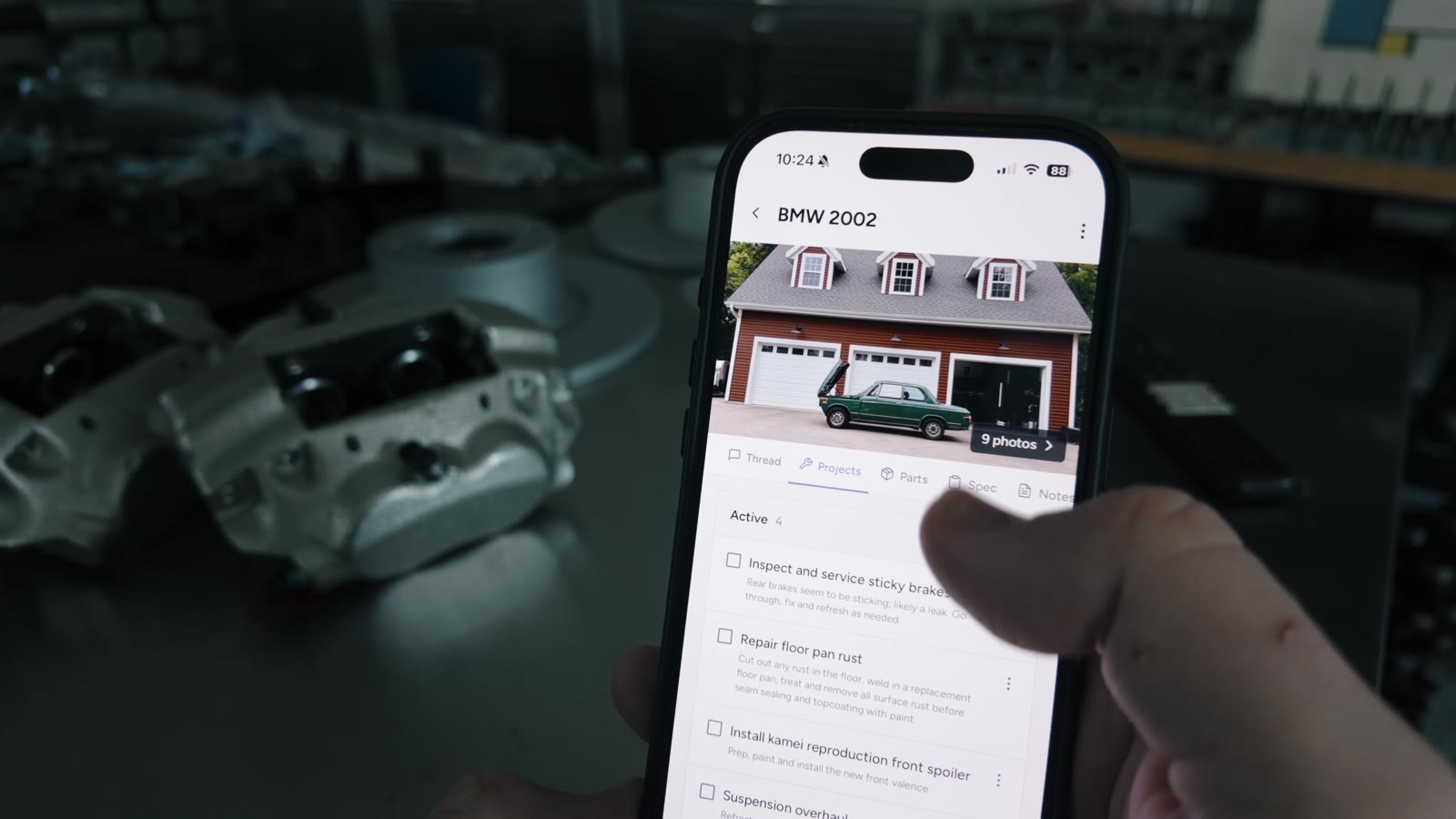 Assembly running on an iPhone in a garage, showing a BMW 2002 project and tasks